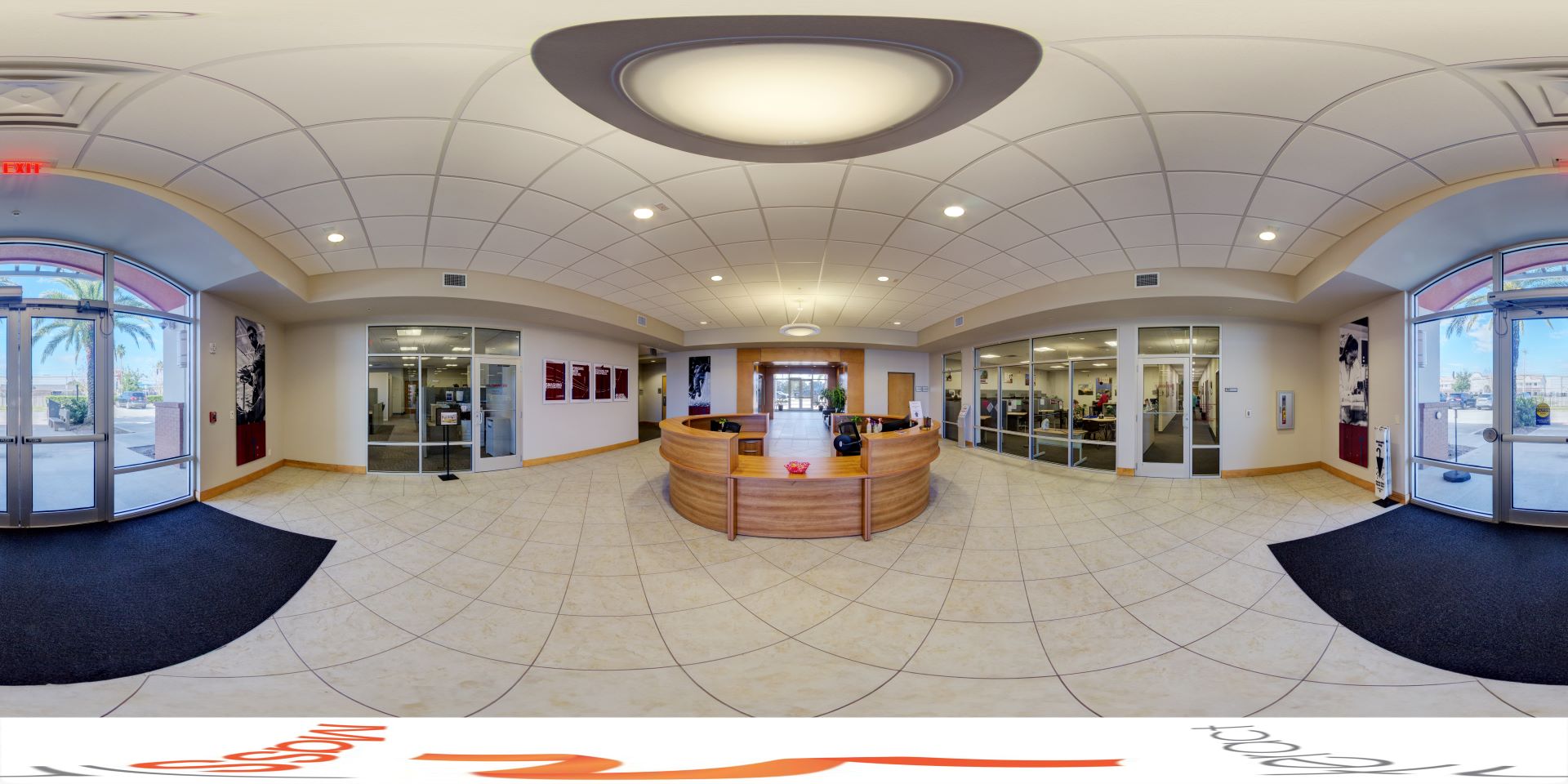 Lobby of the L3Harris Commons at Florida Tech, featuring a circular reception desk and motivational posters on the walls